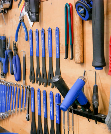 Velo Workshop Red and Blue Bike Tools on the wall.